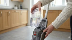 A close-up showing how the water tank clicks securely into the main body of the Bissell steam mop.