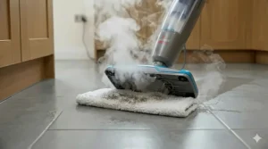 An angled view showing the underside of a Bissell steam mop as it sanitises a kitchen floor with heat.
