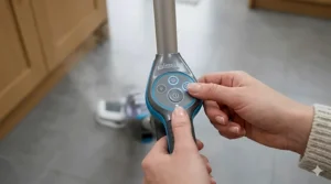 A person’s hands adjusting the variable steam settings on the digital control panel of a Bissell mop.