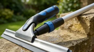 A professional window squeegee attached to a telescopic pole for cleaning hard-to-reach conservatory roof panes.